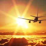 How to travel more - plane at sunset